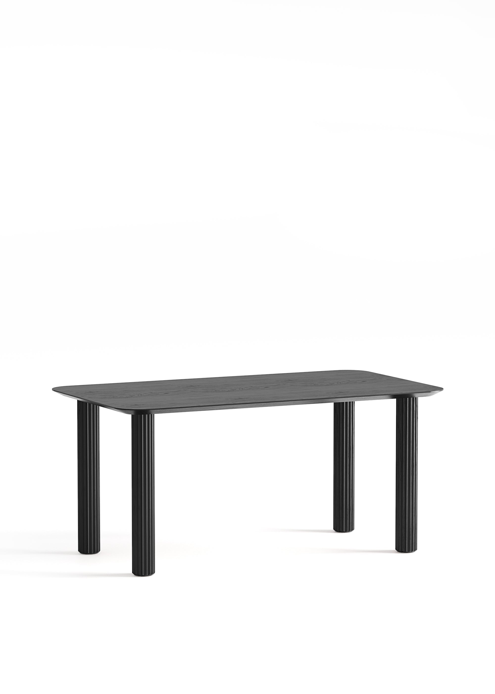 Rectangular black wooden dining table with four fluted cylindrical legs