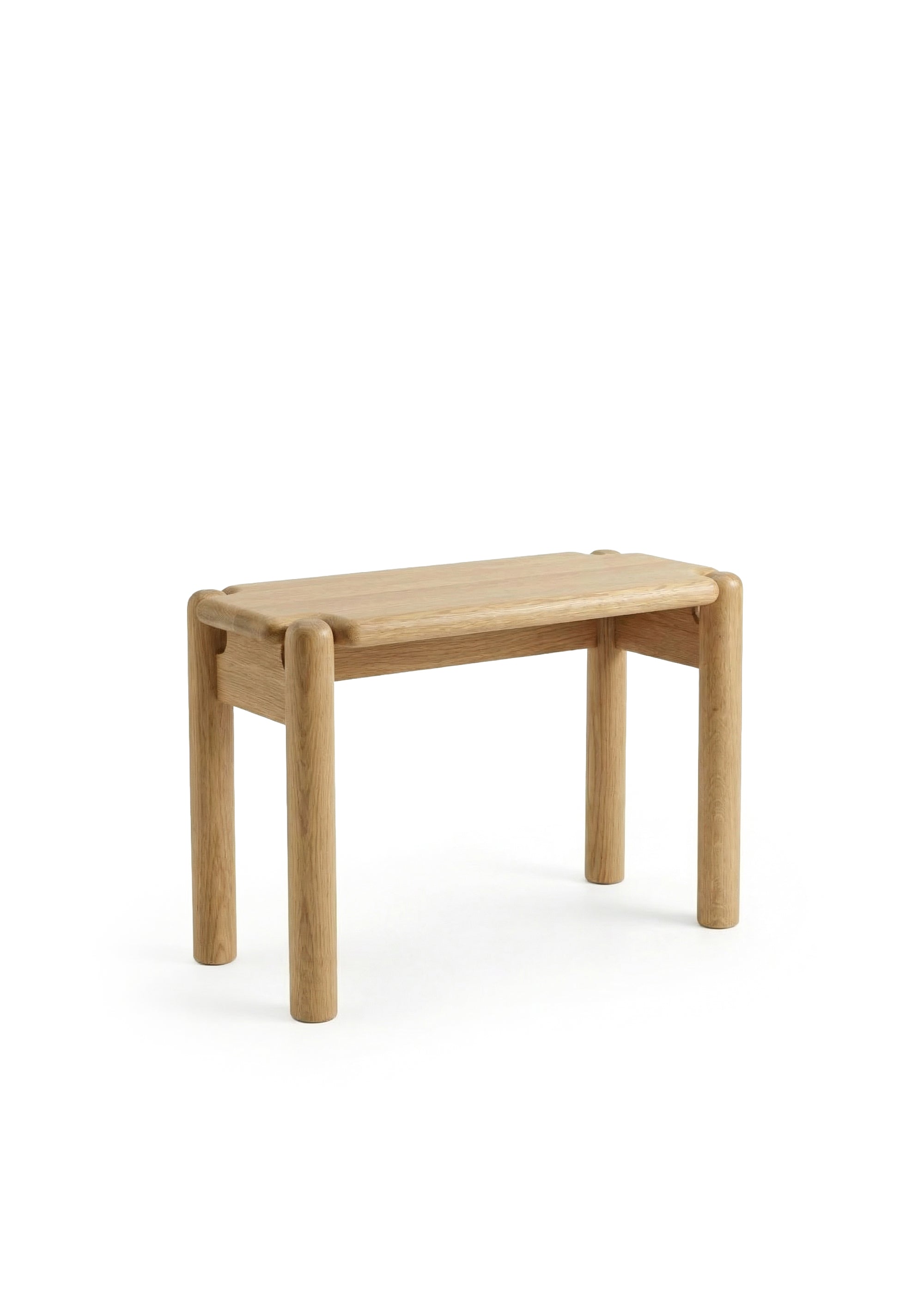 Wooden table in a bright interior with a pendant lamp and small decor objects.