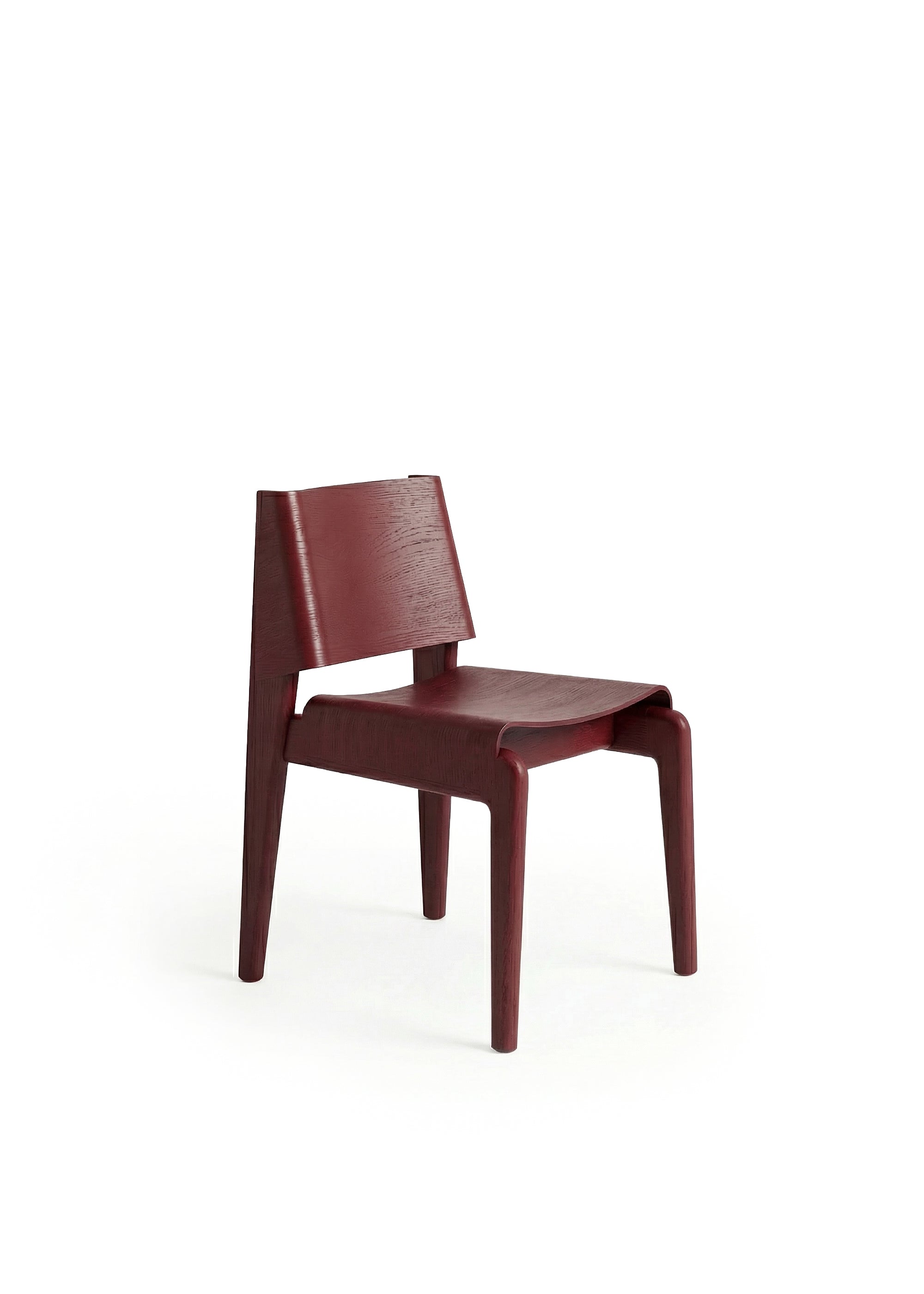 A wooden chair with a curved backrest and angled legs placed in a dimly lit industrial space.
