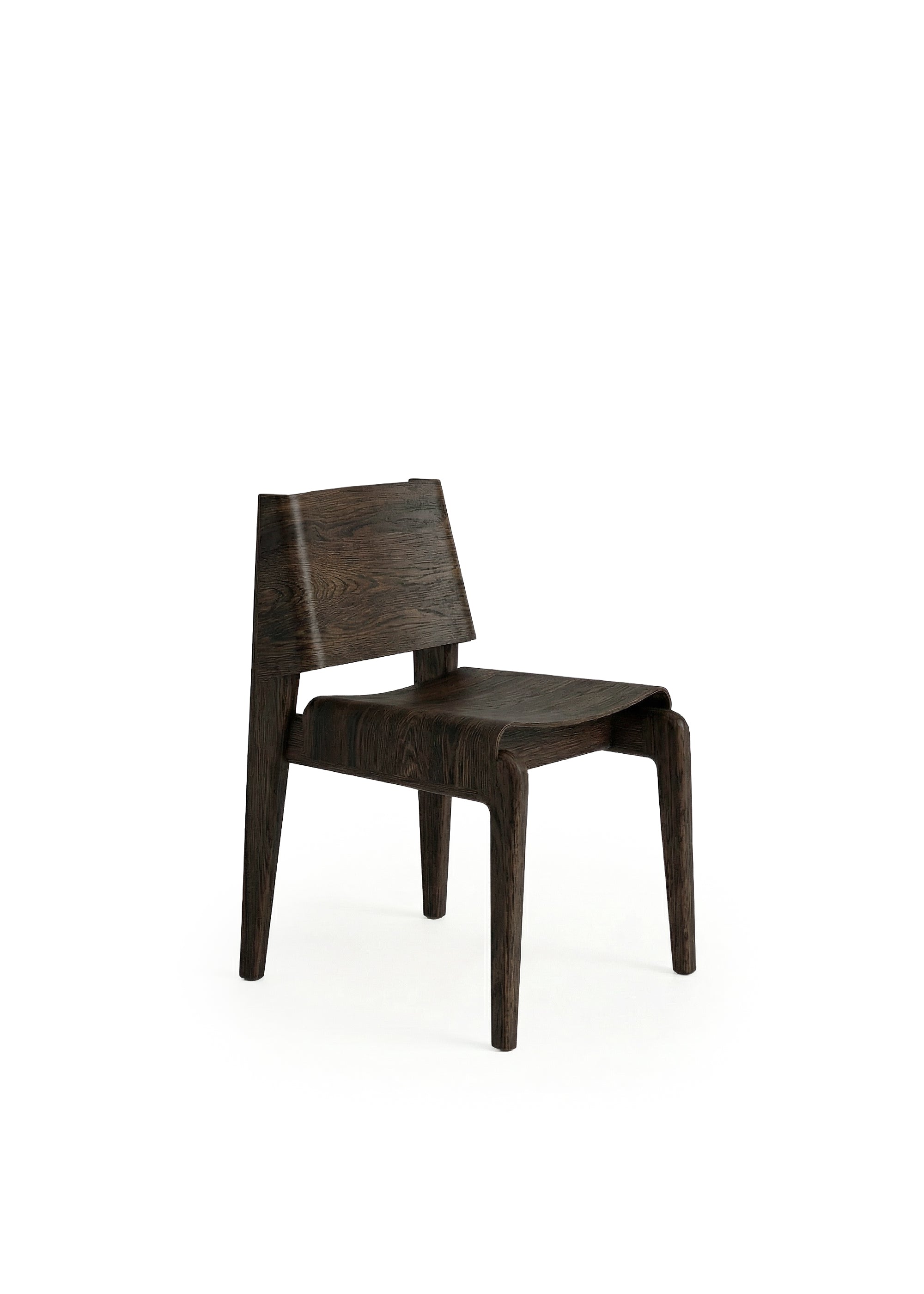 A wooden chair with a curved backrest and angled legs placed in a dimly lit industrial space.