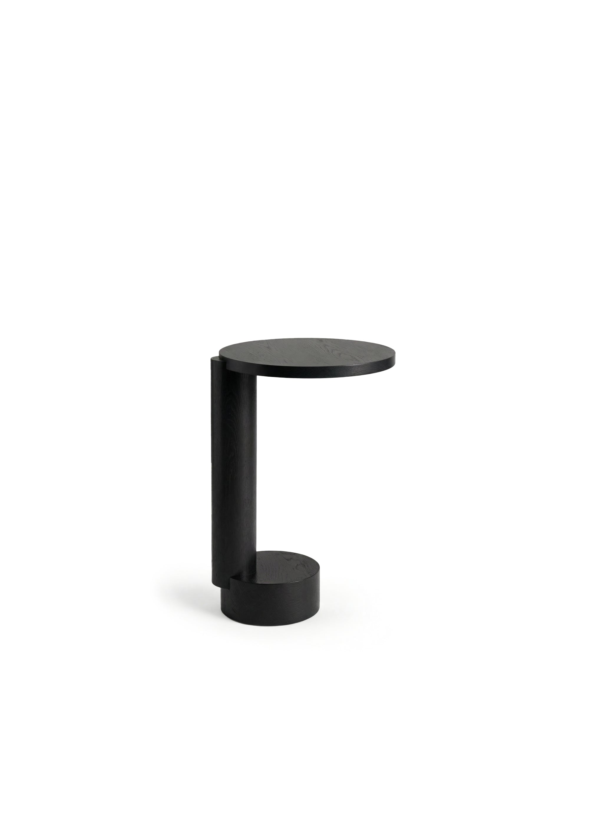 Black modern side table with a round top on a white background.