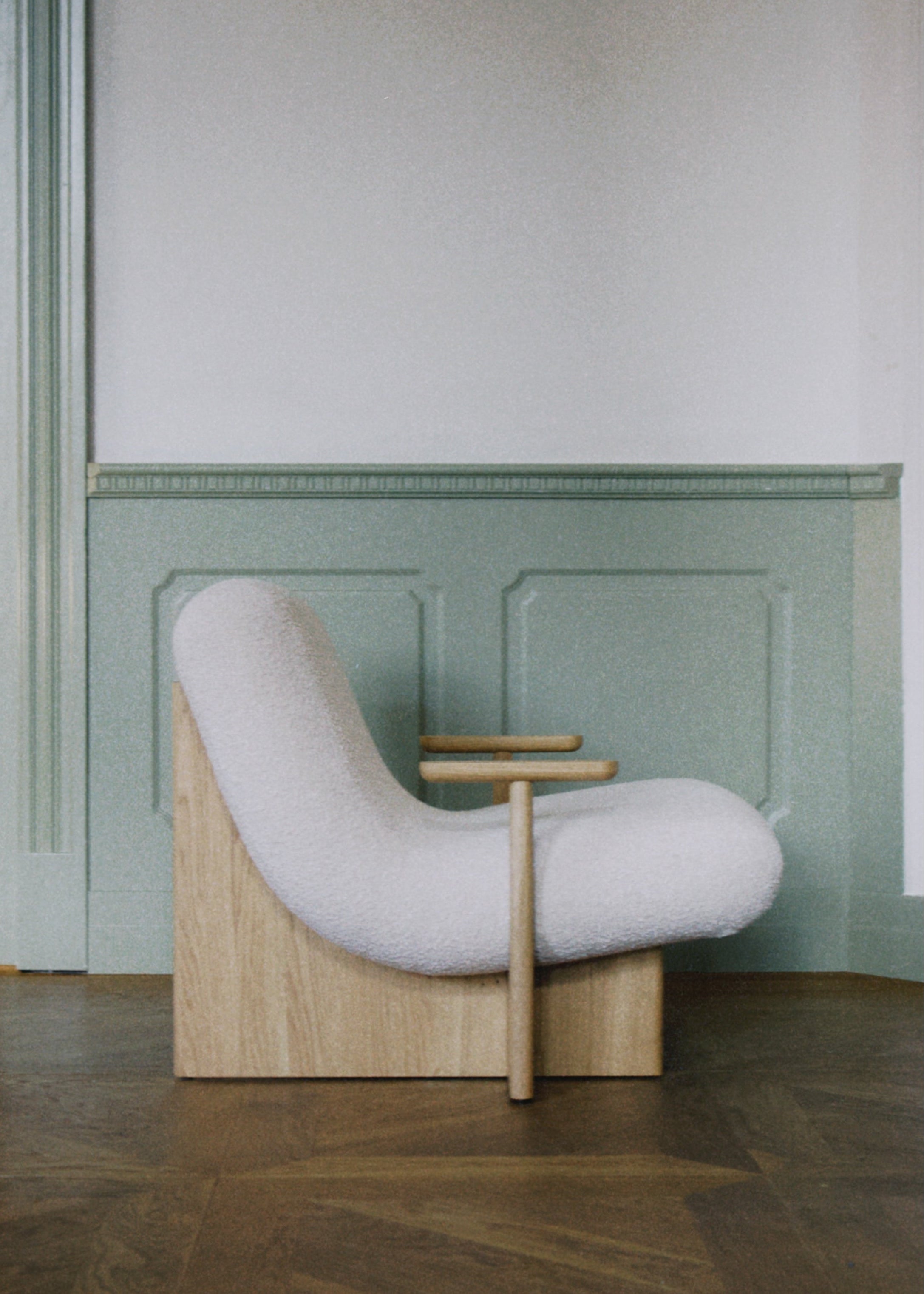 Modern designer lounge chair with wooden frame and soft upholstery