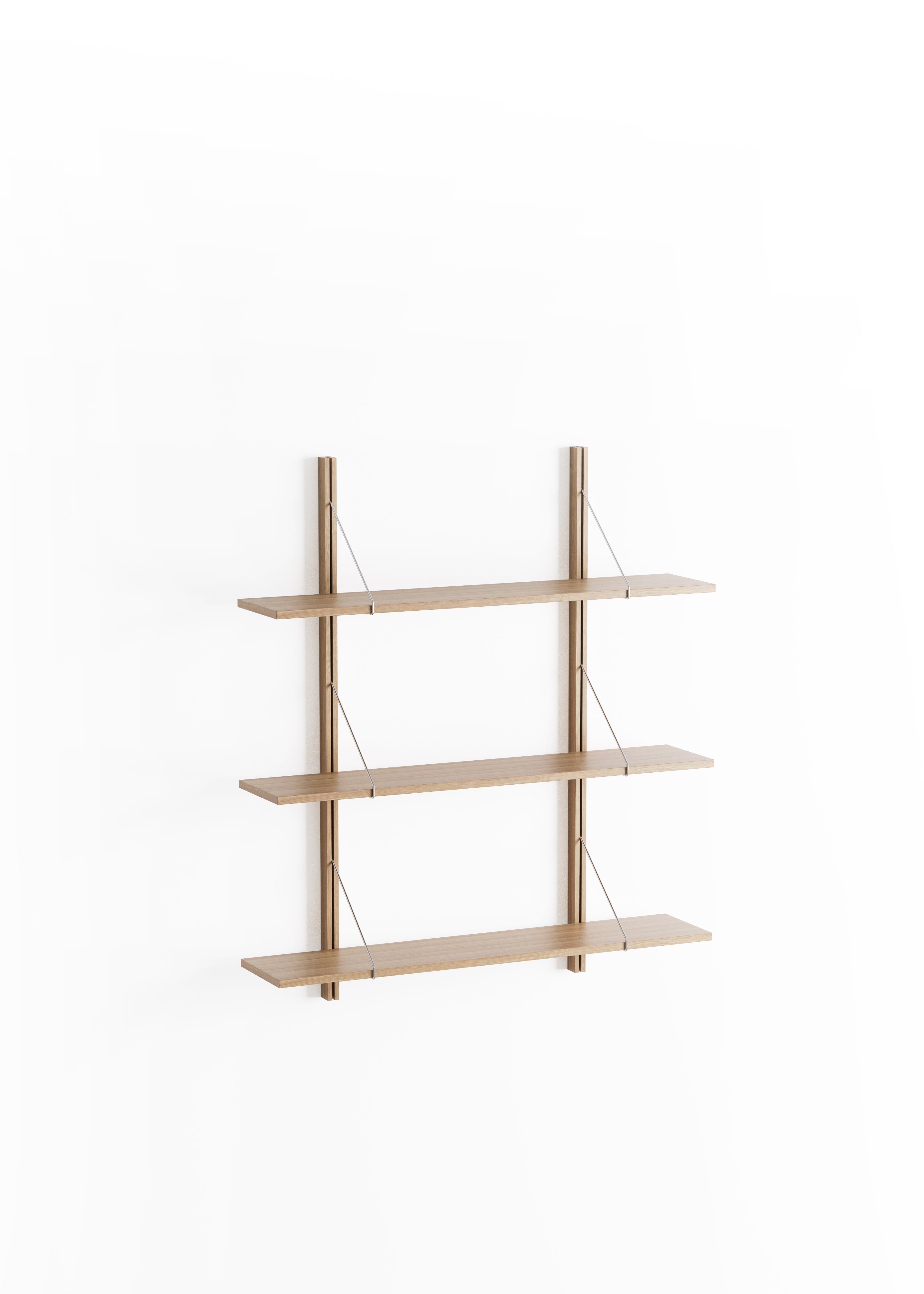 Simple wooden shelves with books and decorations by the window